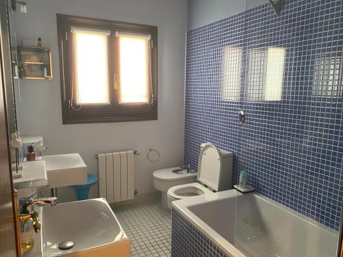 a blue tiled bathroom with a toilet and a sink at Mojacar Villa - Villa Caletta - 4 bedroom - sleeps 8 - R954 in Mojácar