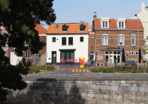 a white building with a sign on the side of a street at Modern Studio & Apartment Roermond in Roermond