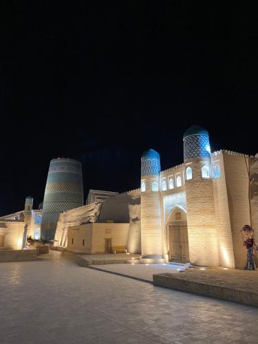 a building with blue lights on it at night at Khiva Bibimariyam in Khiva