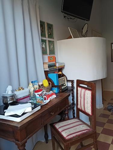 een bureau met een stoel en een tafel met eten erop bij B&B Casa Lulù in Brembate