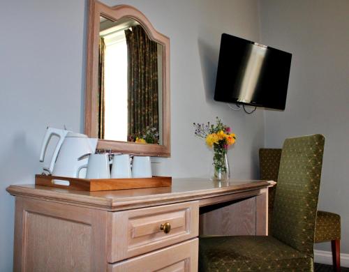 a bathroom with a sink and a mirror at Victoria Square Hotel Clifton Village in Bristol