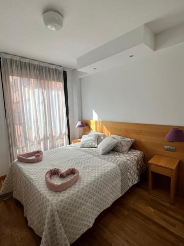 a bedroom with a bed with two donuts on it at Samaniego suite, AirPort, ifema turístico in Madrid