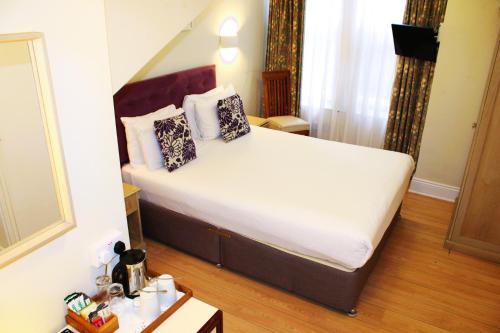 a bedroom with a large bed in a room at Victoria Square Hotel Clifton Village in Bristol