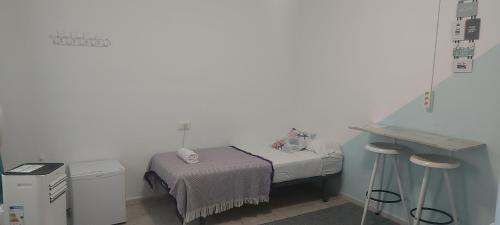 a small hospital room with a bed and a table at Coordenadas Ibiza in Ibiza Town
