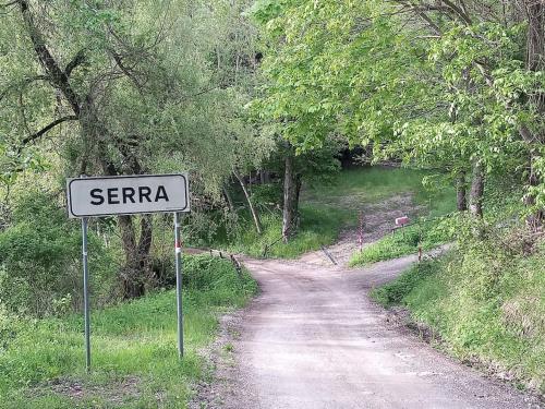 a dirt road with a sign that reads seranza at The house in the paradise of Serra. in Chiusi della Verna