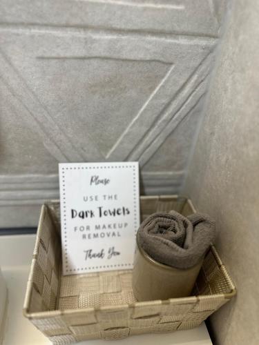 a wooden box with a sign and a donteway for newer towels at La Vista Luxury Villa in Ohrid