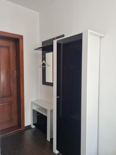 a black and white cabinet in a room with a door at Pensiunea Agroturistica Diana in Măgura