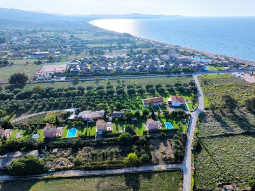 an aerial view of a house next to the ocean at Villa Pami in Almiros Beach
