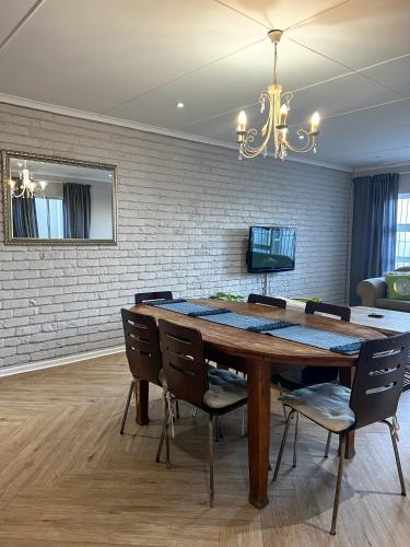 a dining room with a wooden table and chairs at Goulden Street Guest House in East London