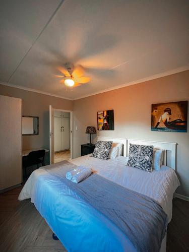a bedroom with a large bed with a ceiling at Goulden Street Guest House in East London