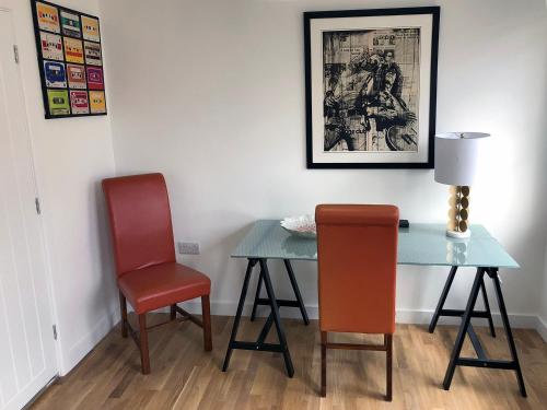 einen Tisch und zwei Stühle in einem Zimmer in der Unterkunft Crown House is a brand new development with unique features in Newbury