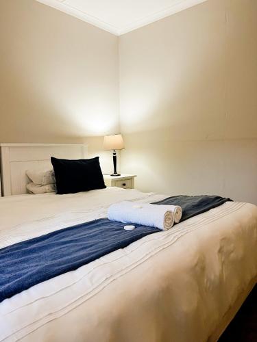 a bedroom with a bed with two towels on it at Goulden Street Guest House in East London