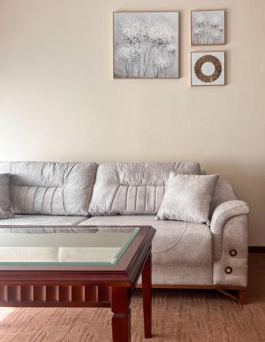 a living room with a couch and a coffee table at Next to the Ski Lift Downtown Bansko in Bansko