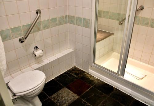 a bathroom with a toilet and a shower at Victoria Square Hotel Clifton Village in Bristol