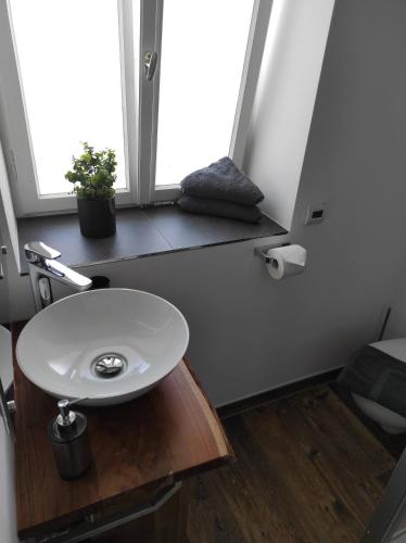 a bathroom with a white sink and a window at Vorderwahllehen in Schönau am Königssee