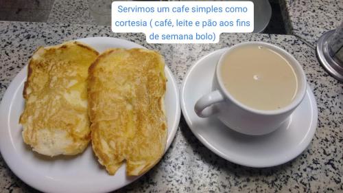 a plate of pancakes and a cup of coffee on a table at Suits - Canto do sabia in Brotas