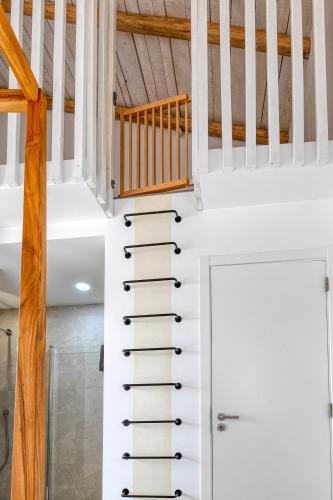a white staircase with a white door in a house at Quinta do Ourives in Carvoeiro