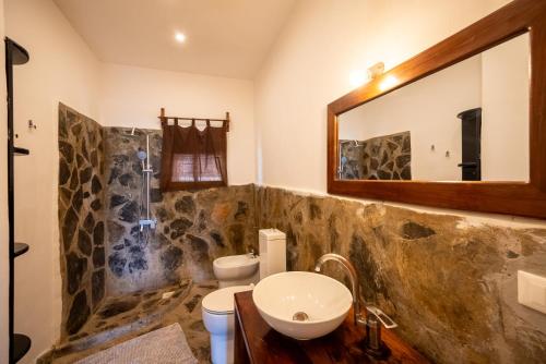 a bathroom with a sink and a mirror at Beachfront Villa Patti ZanzibarHouses in Kiwengwa