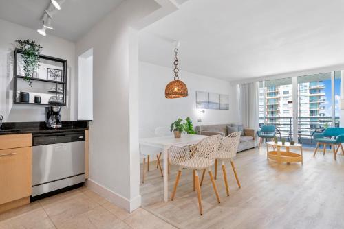 a kitchen and living room with a table and chairs at Avi Lux Stay in Fort Lauderdale