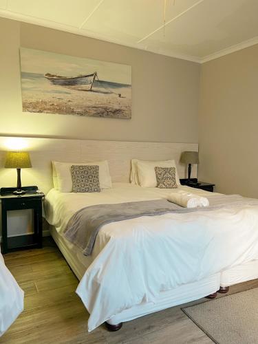 a bedroom with two beds and a painting on the wall at Goulden Street Guest House in East London