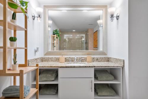 a bathroom with a sink and a mirror at Beach Apartments by Avi Real Estate in Fort Lauderdale