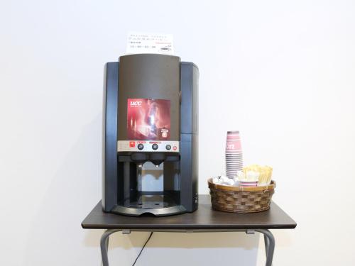 a coffee machine sitting on a table with a basket at Smile Hotel Kumagaya in Kumagaya