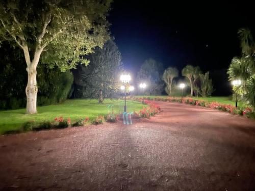 a park at night with a street light and flowers at Domaine du D-DAY in Saint-Côme-du-Mont