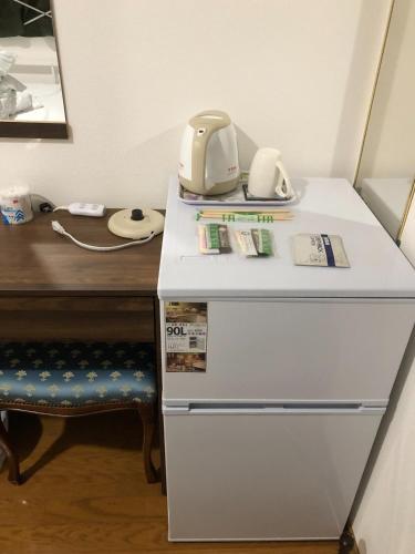 a desk with a phone on top of a refrigerator at HOSTEL198 Private Room of Second floorーVacation STAY68024v in Osaka
