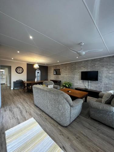 a living room with two couches and a table at Goulden Street Guest House in East London