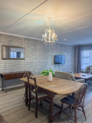 a dining room with a table and a piano at Goulden Street Guest House in East London