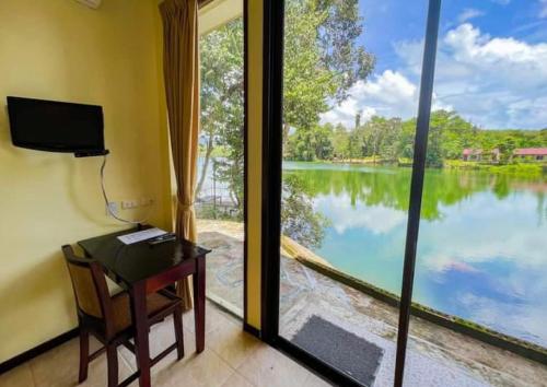 a room with a desk and a view of a lake at Waterjade Resort in Phangnga