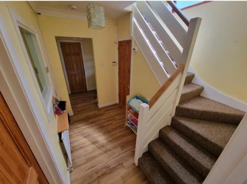 a staircase in a house with a stair case at Beautiful guest house in Longham
