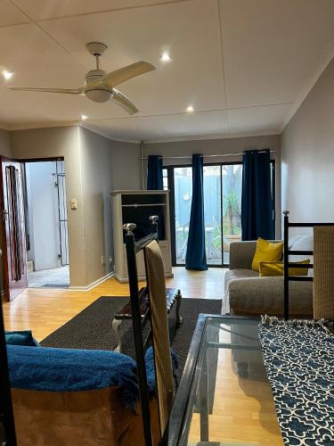 a living room with a couch and a glass table at Goulden Street Guest House in East London