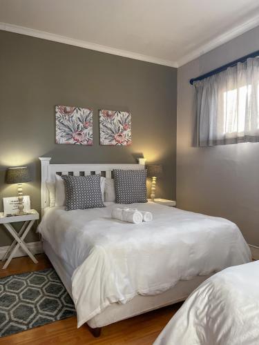 a bedroom with a large white bed and a window at Goulden Street Guest House in East London
