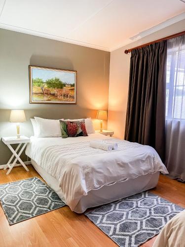 a bedroom with a large white bed and a window at Goulden Street Guest House in East London