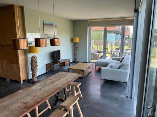 a living room with a couch and a table at Apartment Ostend Dune in Ostend