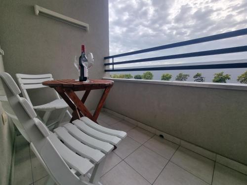 a balcony with a table and chairs and a window at CityLux Doboj in Doboj
