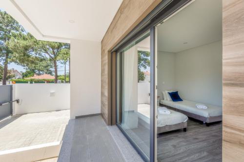 Habitación con vistas a una cama y una ventana en Moradia familiar v4 com piscina, en Fernao Ferro