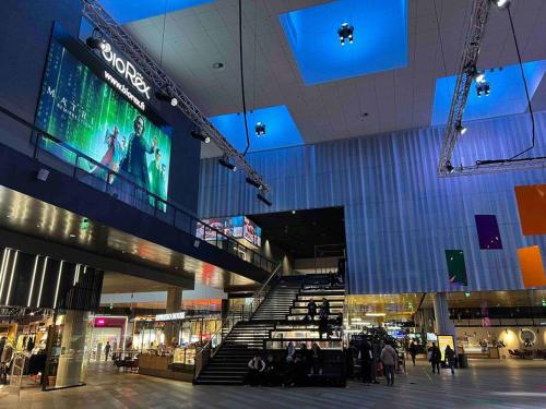 a view of a shopping mall with a large screen at Brand new modern condo built-in Mall of Tripla in Helsinki
