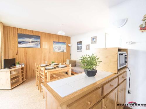 Il dispose d'une cuisine et d'un salon avec une table et un réfrigérateur. dans l'établissement Appartement T3 6 pers. à St-Lary Soulan - Proche télécabine et thermes, avec jardin et parking privé - FR-1-296-125, à Vielle-Aure