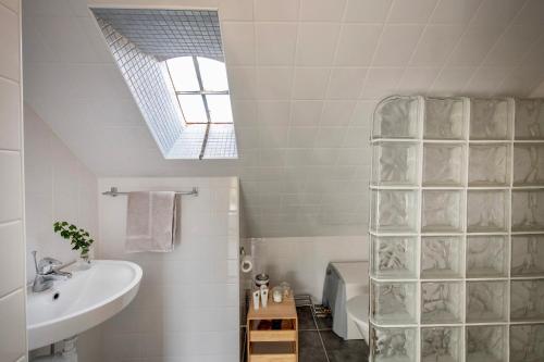 a bathroom with a sink and a toilet and a window at Modern house in Ronneby near lake and sea in Ronneby