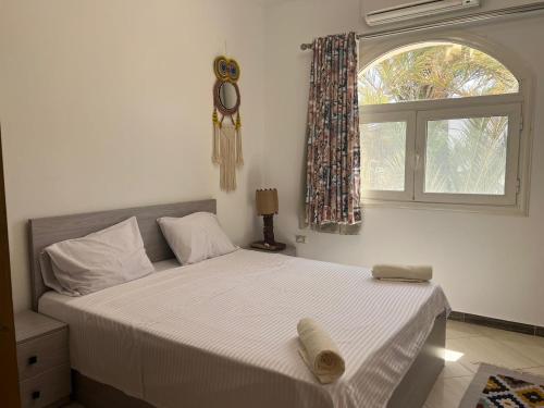 a bedroom with a large bed with a window at Beit Tolba in Dahab