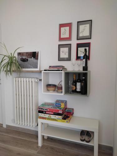 a room with a white table and a shelf with books at B&B Il giardino segreto in Guarda Ferrarese