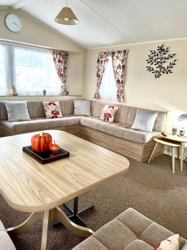 a living room with a couch and a table at 6 Birth Caravan Ingoldmels in Ingoldmells