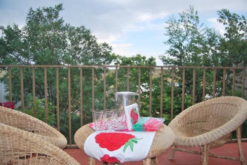 a table with a drink pitcher and chairs on a patio at Casa rural Puente Mocho in Ledesma