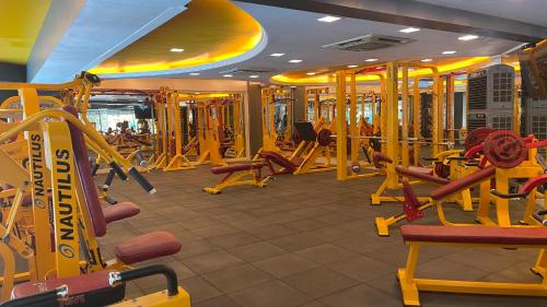 a gym with a bunch of treadmills and machines at Home2 Renaissance Club in Mumbai