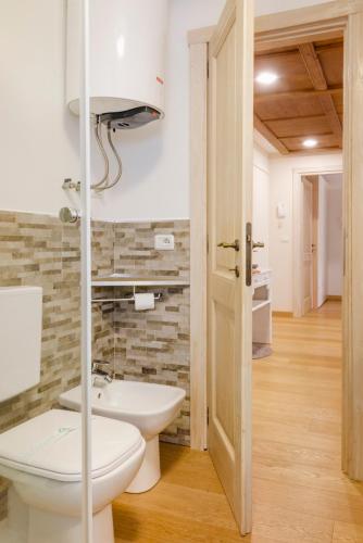a bathroom with a toilet and a sink at Stella Alpina House in Courmayeur