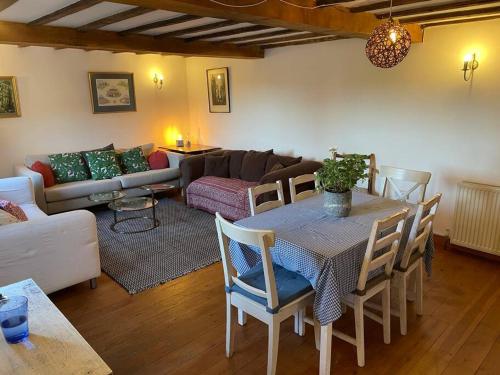 a living room with a table and a couch at Annex at Southfields in idyllic Hampshire village in Greywell