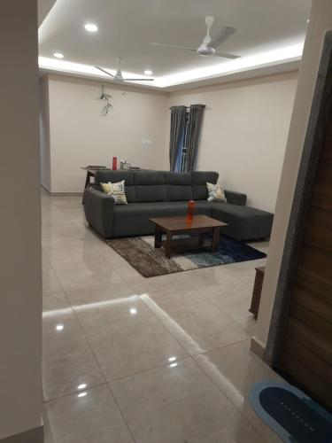 a living room with a couch and a coffee table at Swayamkrushi 3rd Floor in Hyderabad