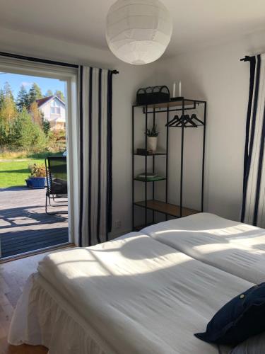 a bedroom with a bed and a sliding glass door at Ett rum & kök in Bålsta